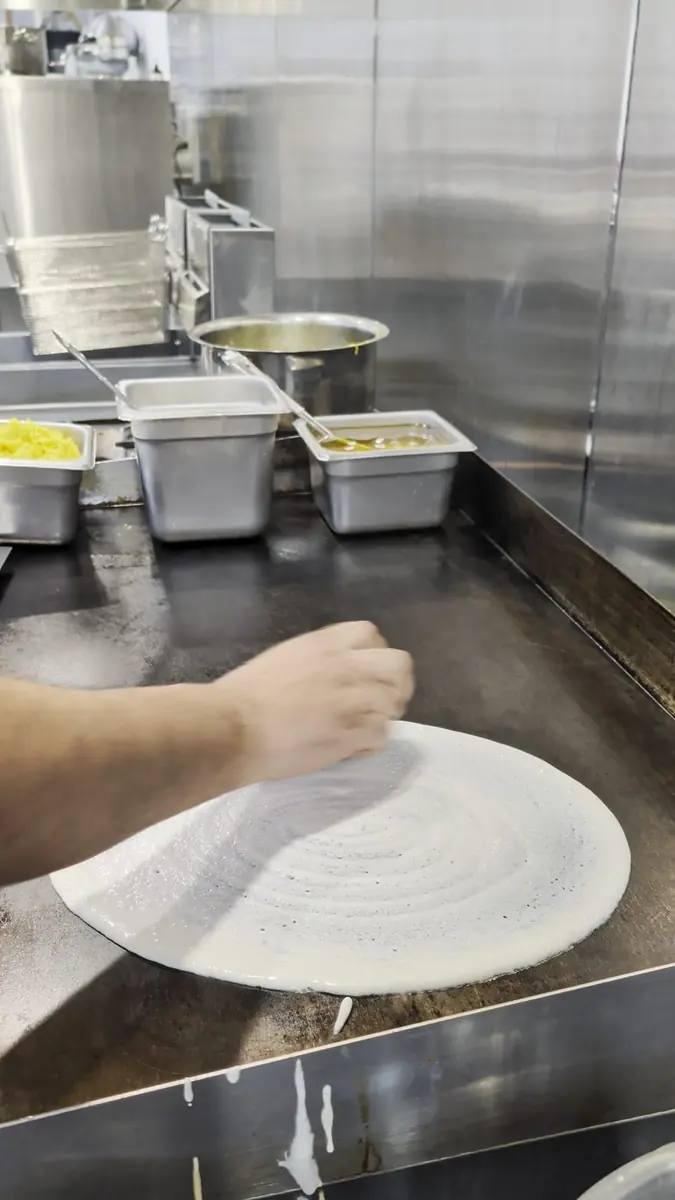 Dosa batter hitting the tawa