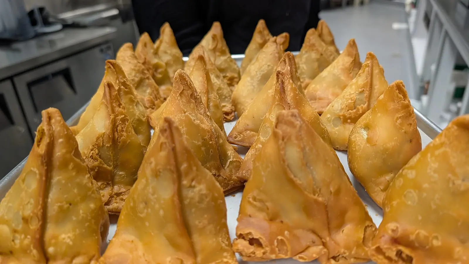 Golden samosas fresh from the fryer