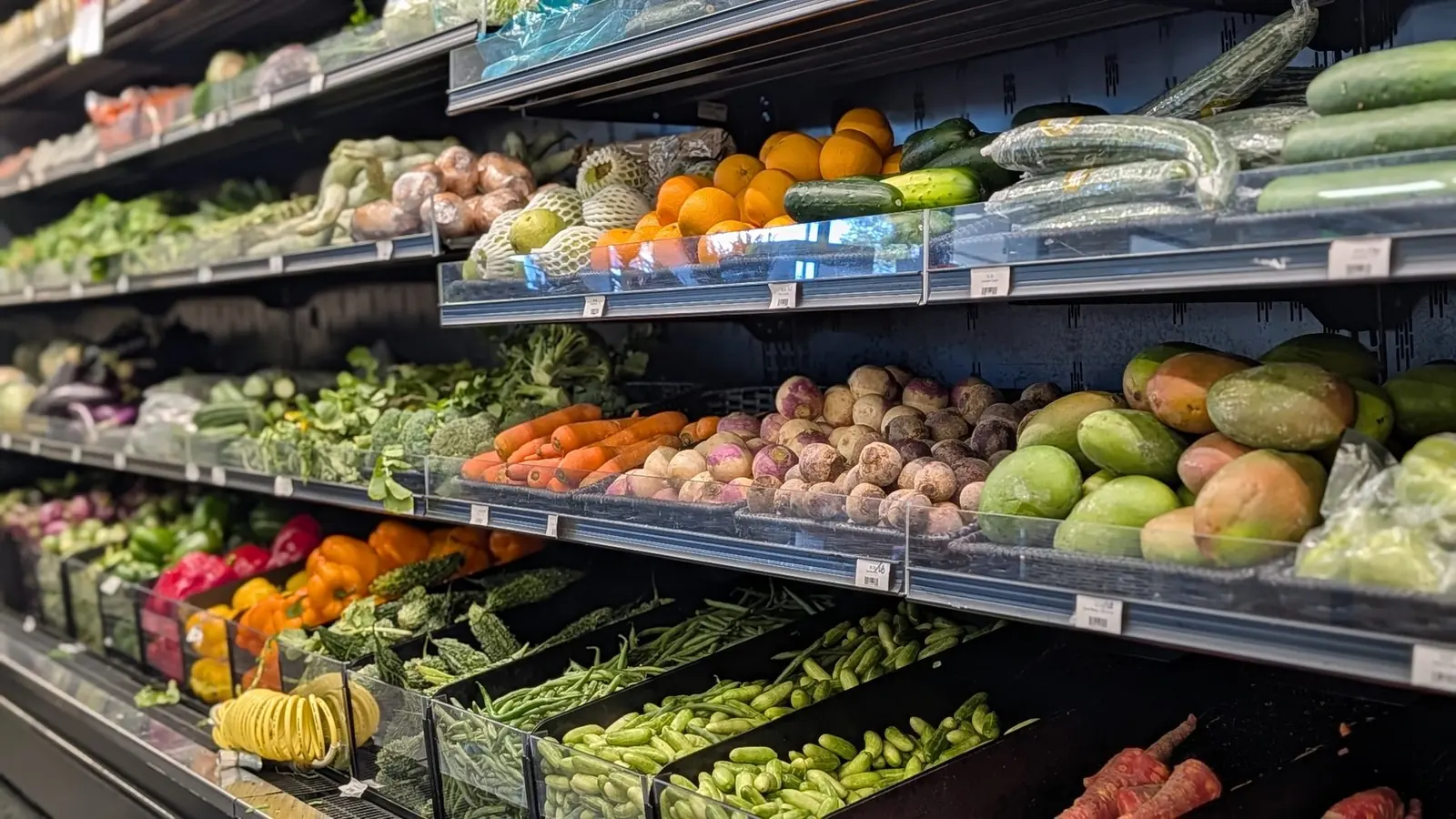 Vegetable shelves with mangoes, okra and gourds